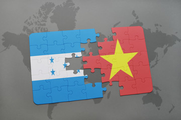 puzzle with the national flag of honduras and vietnam on a world map