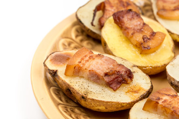 Baked potatoes with skin and bacon on it