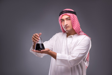 Arab with oil on gray background