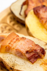 Closeup macro baked potatoes with fried bacon
