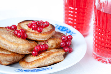 Pancakes with berries red currant and juice
