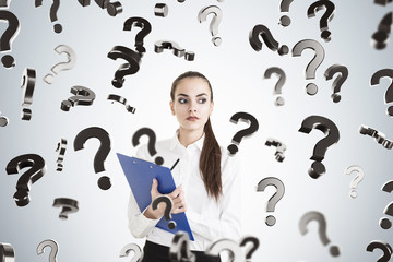 Serious woman with clipboard and questions