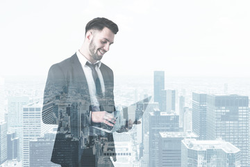 Fototapeta premium Bearded man with laptop in gray city