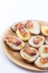 Fried bacon on baked potatoes with copy space