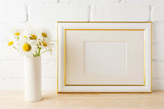 Gold decorated landscape frame mockup with daisy flower in vase