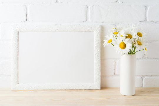 White landscape frame mockup with daisy flower in styled vase