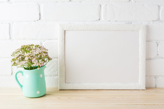 White landscape frame mockup with soft pink flowers in pitcher