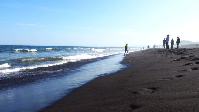 parents with children spend time on the beach