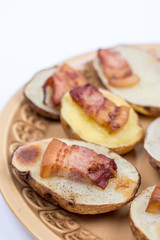 Fried bacon on baked potatoes with copy space