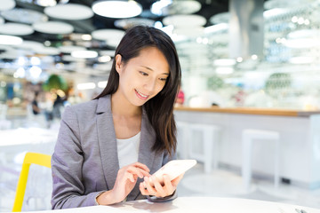 Businesswoman use of cellphone in co working space