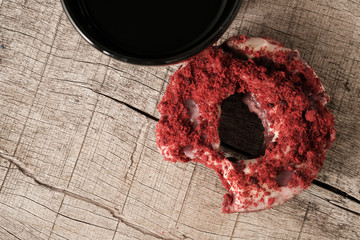 Top view of red velvet donut on wooden table