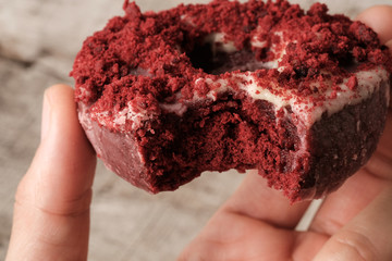 Close up bite missing red velvet donut