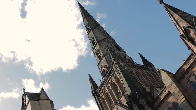 Angled shot showing the Gothic Architecture of Lichfield cathedral, silhouetted against the sky