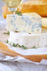 Cheese plate with different kinds of cheese with white wine