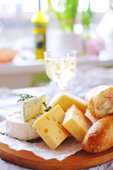Cheese plate with different kinds of cheese with white wine