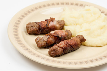 Grilled kebabs in bacon with mashed potatoes