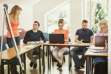 Students and teacher tutor in classroom