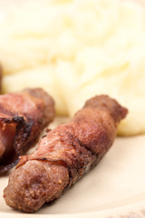 Grilled kebabs in bacon with mashed potatoes