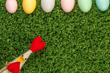 Easter spring eggs and chicken on green grass background