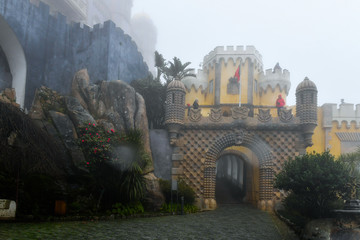 Fototapeta na wymiar Pena Palace on a foggy and rainy day, Sintra, Portugal