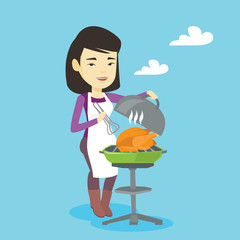 Woman cooking chicken on barbecue grill.