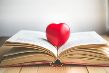 red heart on open book with copy space in relaxation and cozy mood, Image for education, love and brightness  concept