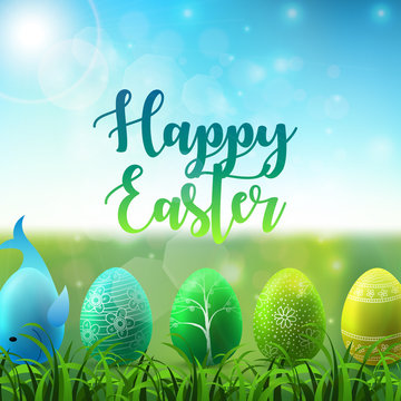 Easter background with colorful easter eggs in the grass on sunny sky background