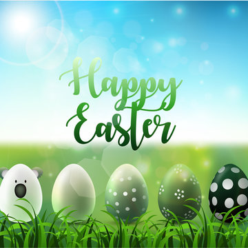 Easter background with easter eggs in the grass on sunny sky background