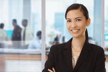 Smiling asian businesswoman in office