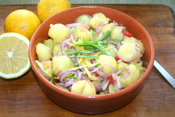 Potato salad with lemon marinade, national cuisine, potatoes, lemons, red onions, Armenian cuisine, Korean cuisine, cold appetizer of potato salad in the pottery, rustic food, peasant food,