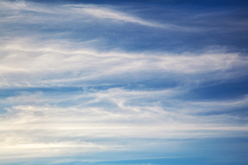 White wavy clouds on blue sky, background