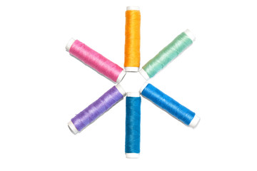 Colorful thread spools for sewing or embroidery isolated on white background