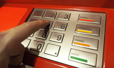 ATM pin button close-up and human hand index finger.