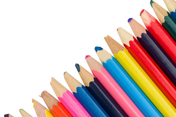 Colored pencils diagonally on a white background