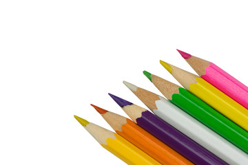 Colored pencils in the corner on white background