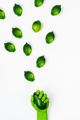 Spring concept of fresh green limes and hand painted green.