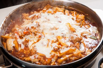 Spicy Stir-fried Chicken with cheese. It's a Korean style cuisine.