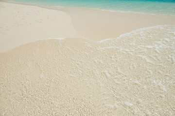 sandy beach and clear transparent sea wave
