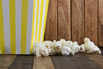 A box of popcorn on wooden background