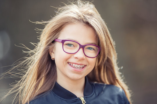 Girl. Teen. Pre teen. Girl with glasses. Girl with teeth braces. Young cute caucasian blond girl wearing teeth braces and glasses.