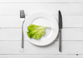 White plate with lettuce, vegeterian, topview