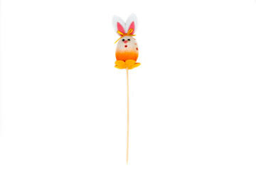 Decorative hare/ rabbit with wooden stick. Easter, spring, summer decor. Cute Interior object. Orange hare isolated on the white background. Front view.
