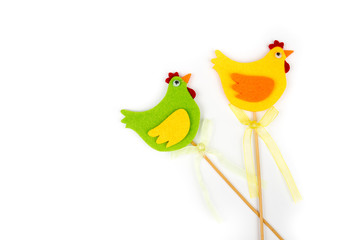 Decorative rooster and hen with wooden stick. Easter decoration. Interior decor. RIsolated on white background. Side view. Place for text, copy space.