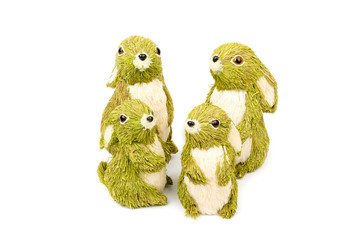 Decorative hare/ rabbit. Easter, spring, summer decor made from natural green, cream white straws. Mother, father and children. Hare family isolated on the white background. 