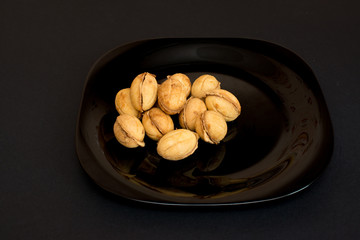 Nutlet with condensed milk On a black plate