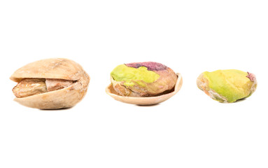 Three pistachio nuts in shell and without on a white background