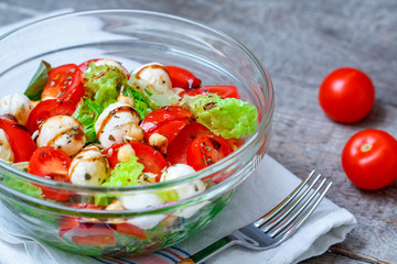 Colorful summer salad with tomatoes, mozzarella and chickpeas.