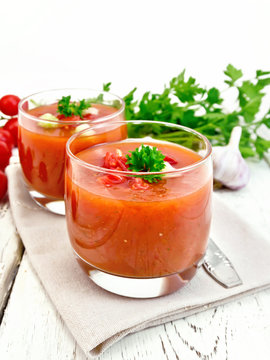 Soup tomato in two glasses with parsley on board