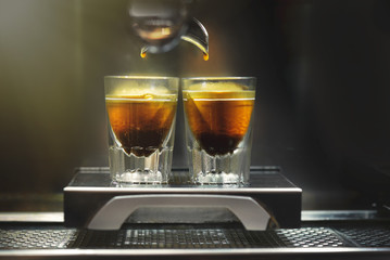 Professional coffee brewing. Coffee espresso. Close-up of espresso pouring from coffee machine to...