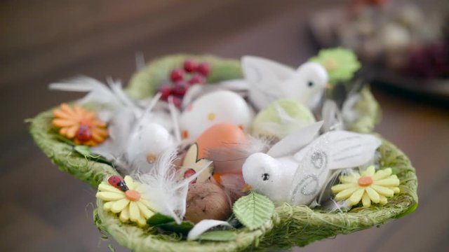 Easter eggs in a green basket with birdies.Easter decoration.Video rotation